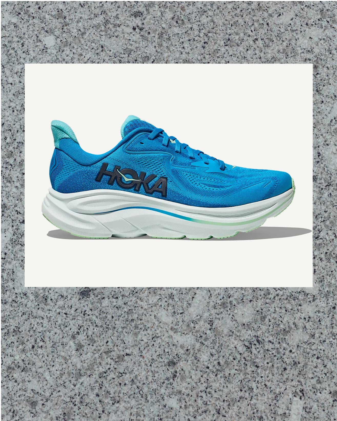 Blue running shoe with a white sole, displayed against a light gray textured background.