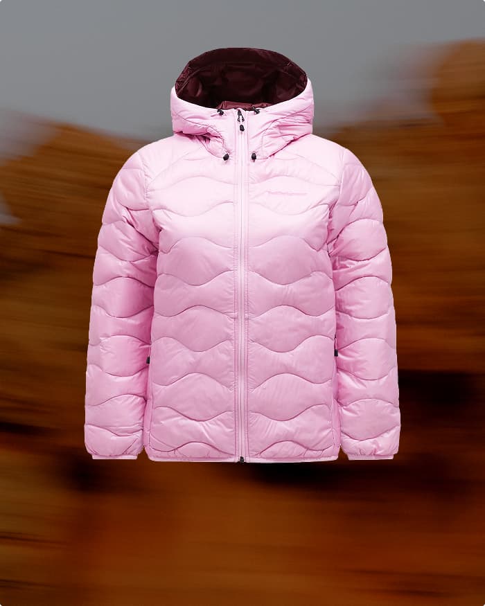 Pink puffer jacket with a wave pattern, front view, set against a blurred brown background.