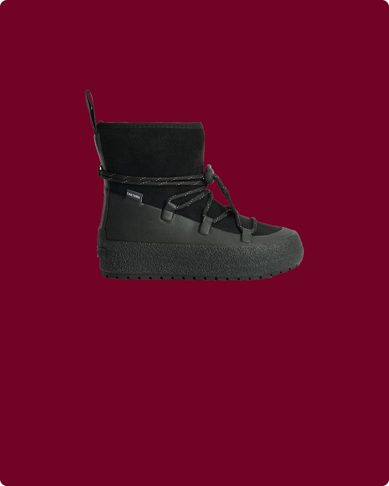 Black shoe on a maroon background.