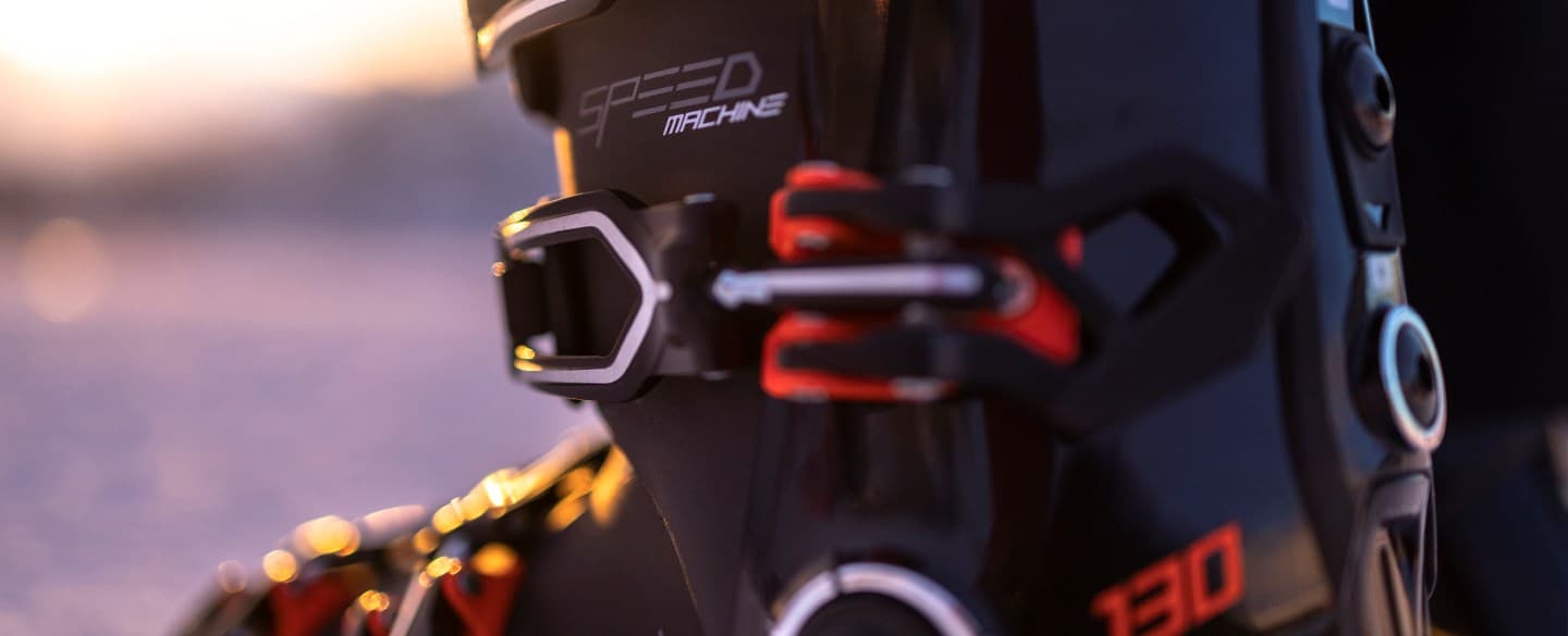 Close-up of a black ski boot with red and white accents.