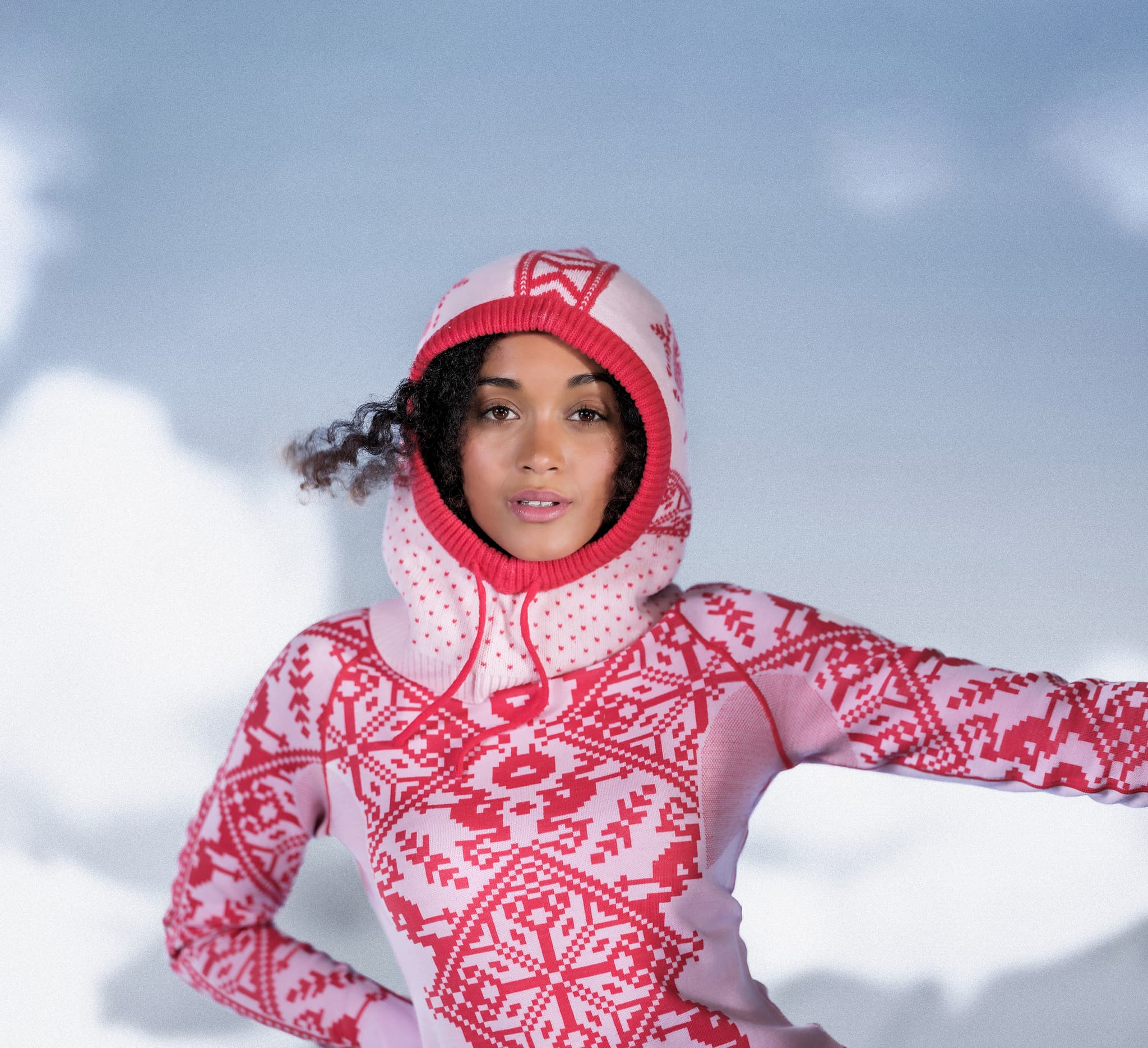 Woman wearing a pink base layer and knitted balaclava
