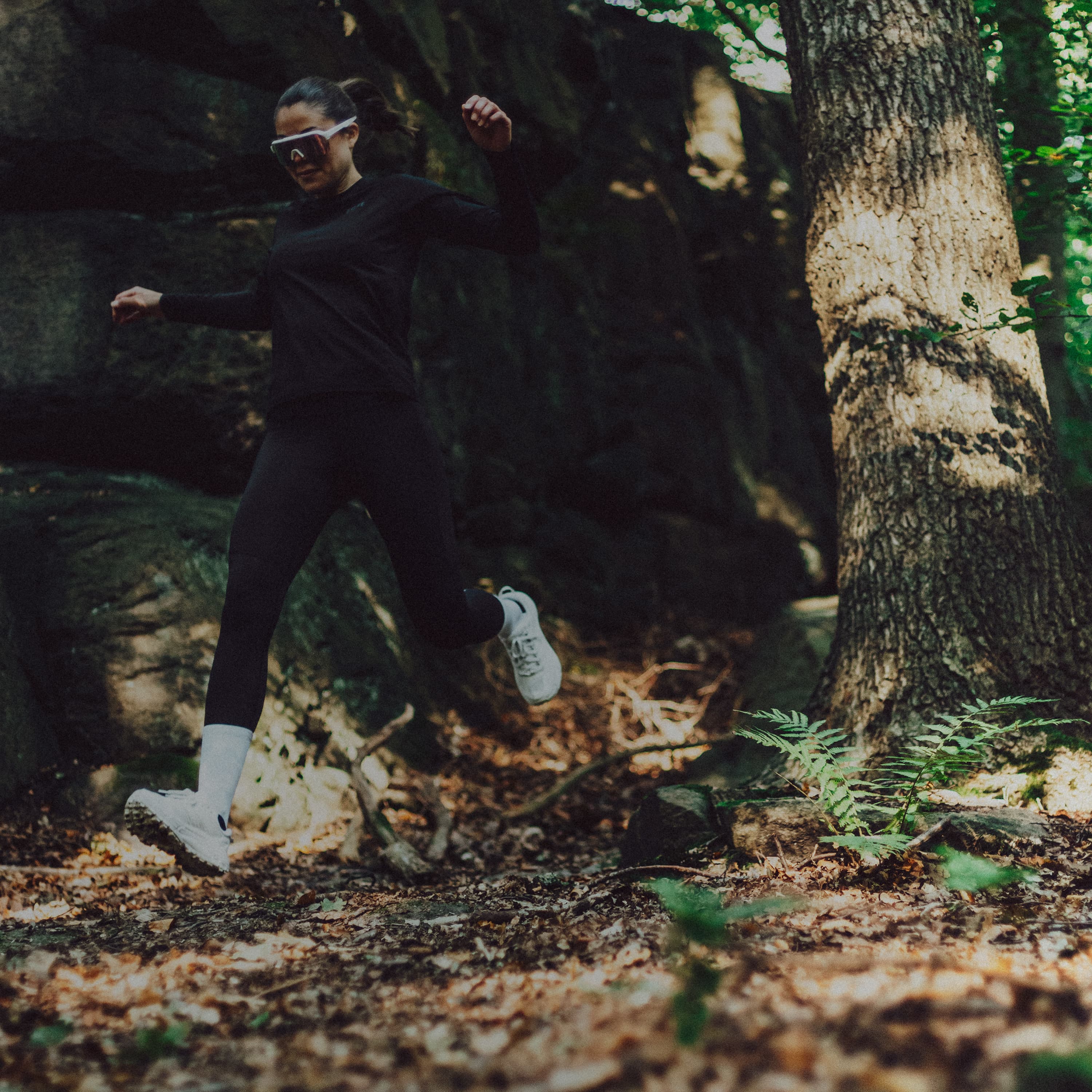 Woman trail running in the forest