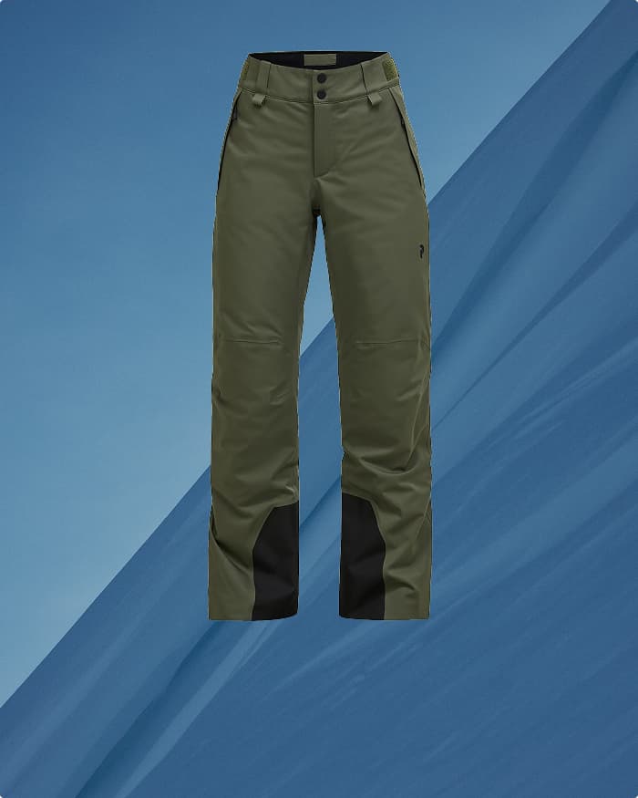 Olive green cargo pants with black patches on the inner legs, displayed on a blue background.