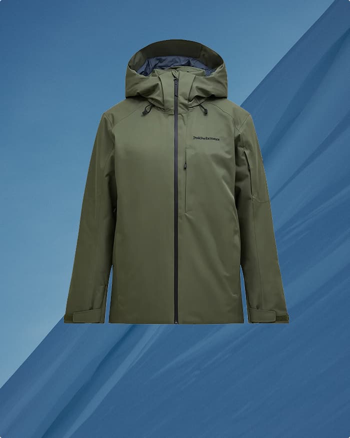 Green hooded jacket with zippers on a blue background, displayed from the front.