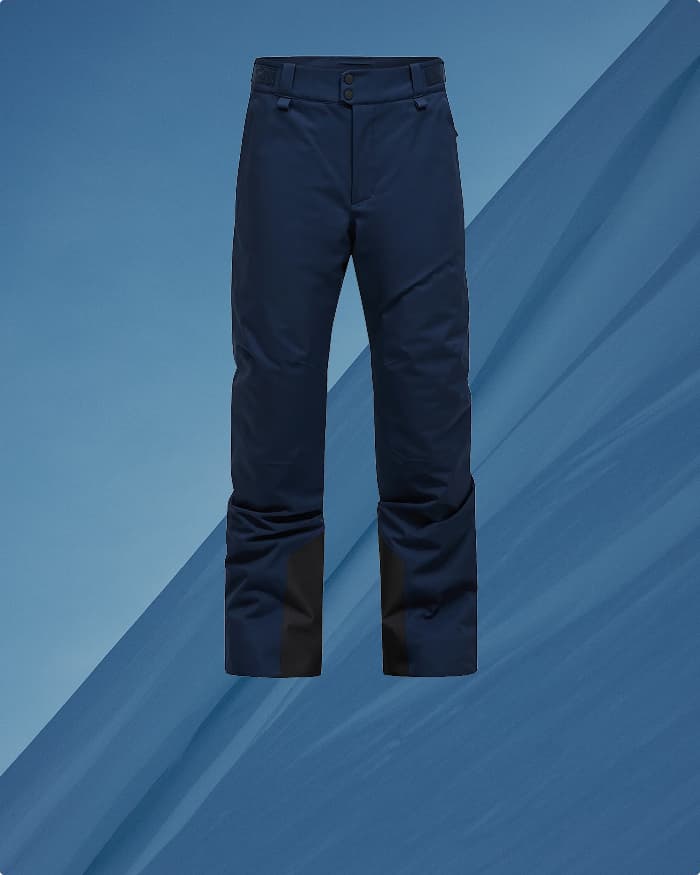 Dark blue pants with a button and zip closure, against a blue abstract background.